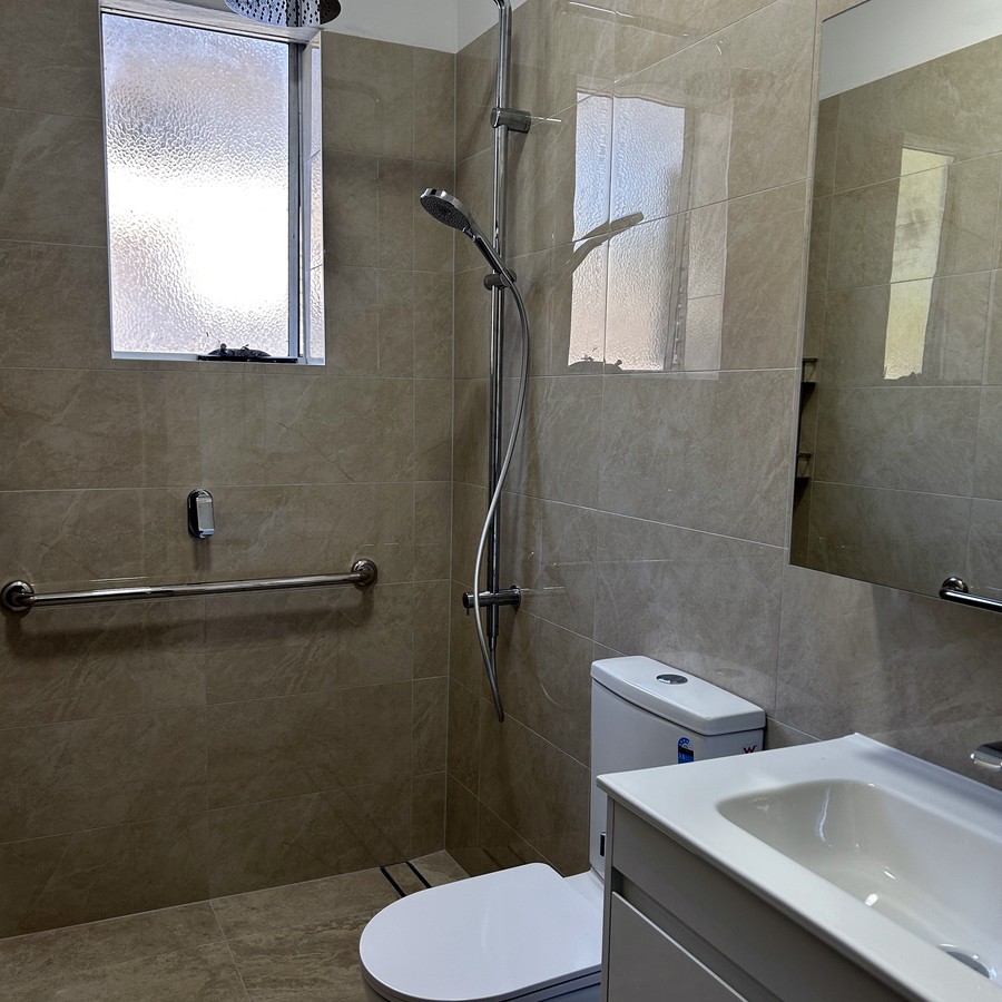 Accessible bathroom with grab rails and a vanity