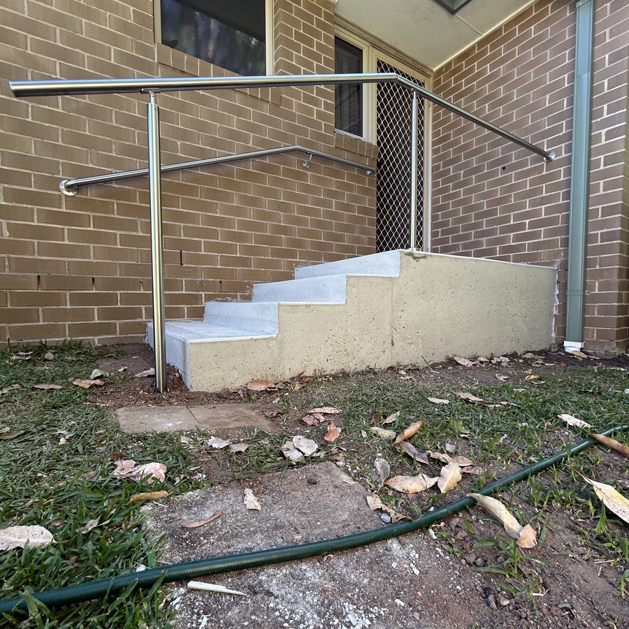 Concrete steps and landing with a handrail
