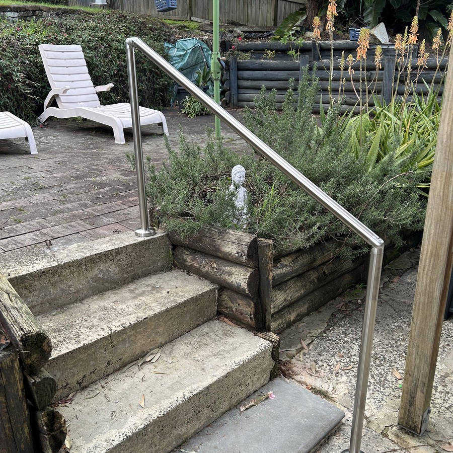Concrete garden steps with a stainless steel handrail