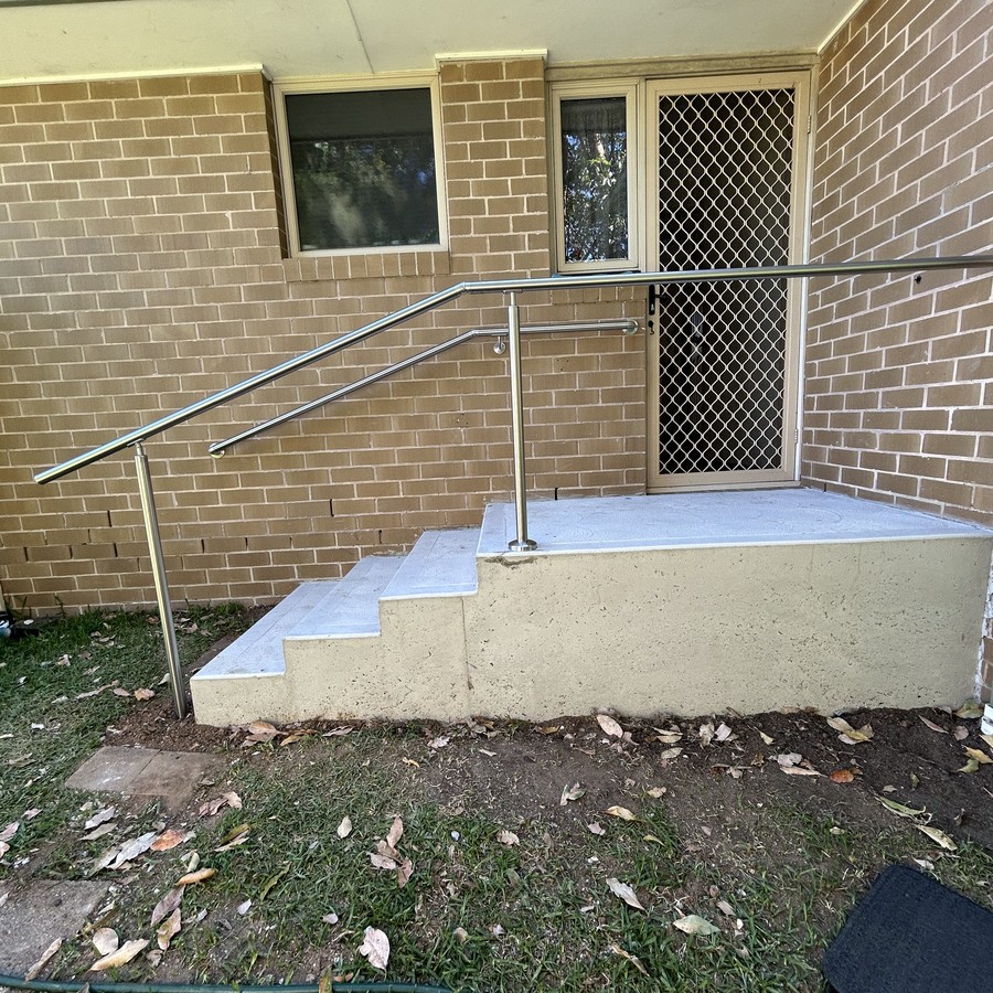 Concrete landing and steps with a handrail