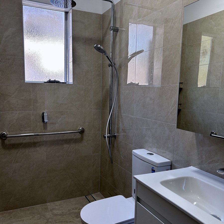 Accessible bathroom with shower grab rails for safe, independent use
