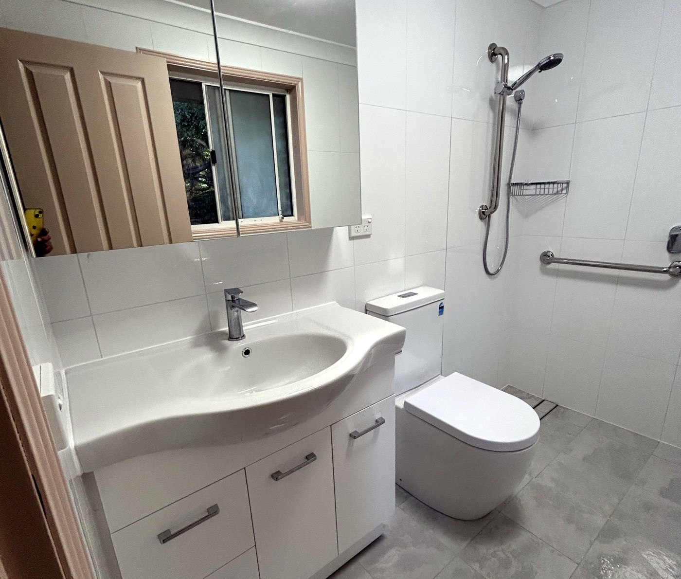 Full accessible bathroom with grab rails, level-entry shower and comfort-height fixtures in Sydney