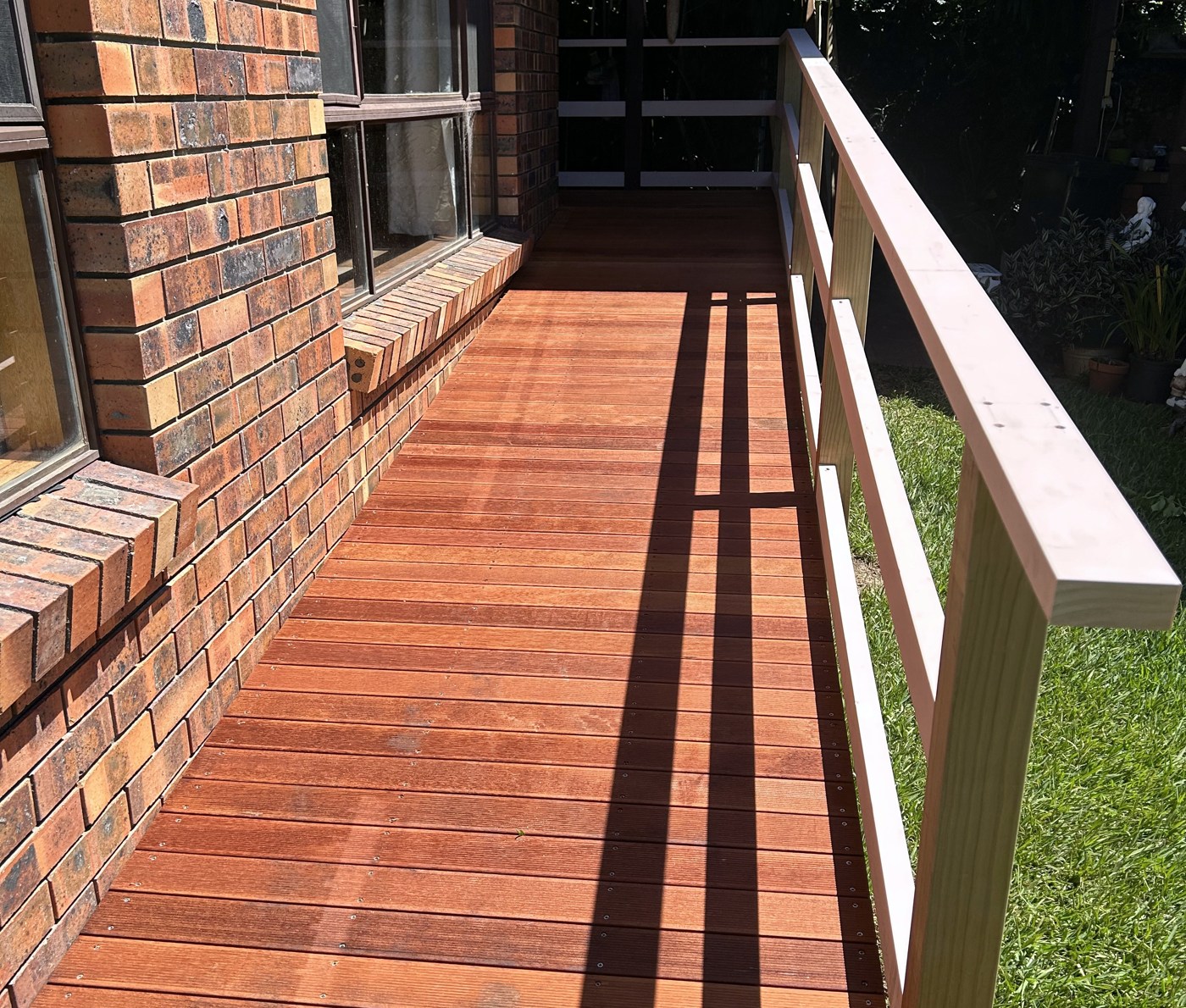 Timber access ramp with a glass and stainless balustrade