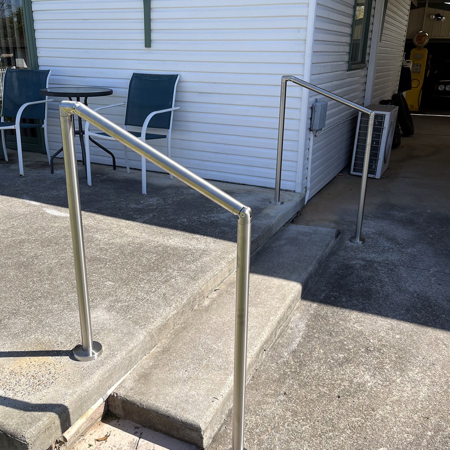 Stainless steel handrail to a ramp and step at a home entrance