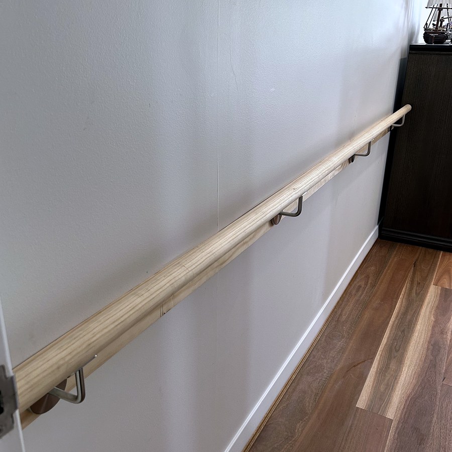 Timber internal handrail mounted along a wall