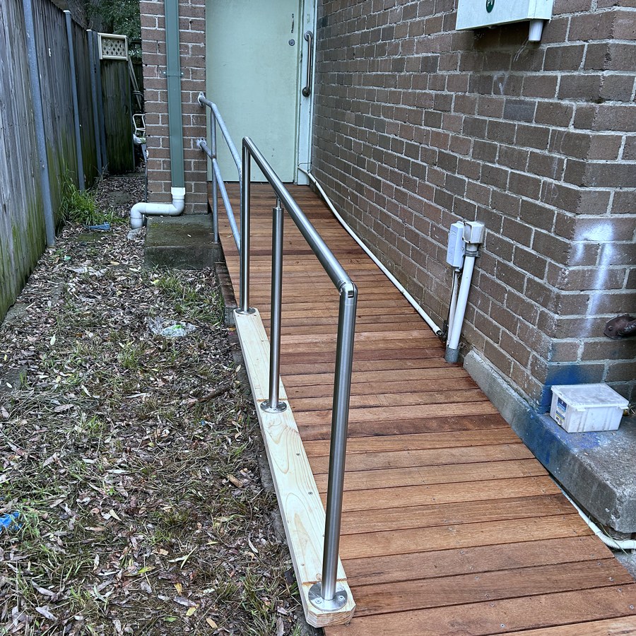 Stainless steel handrails fitted along a timber access ramp