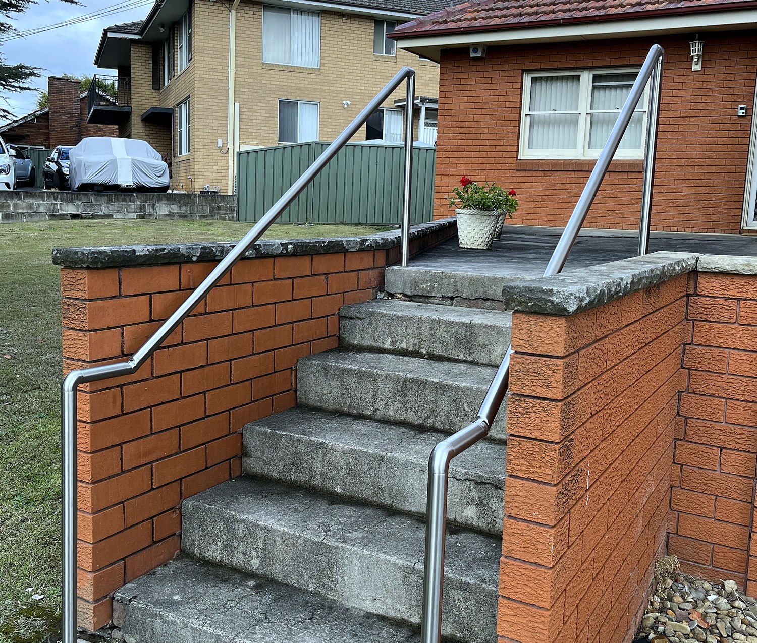 Stainless-steel handrails on brick entry steps
