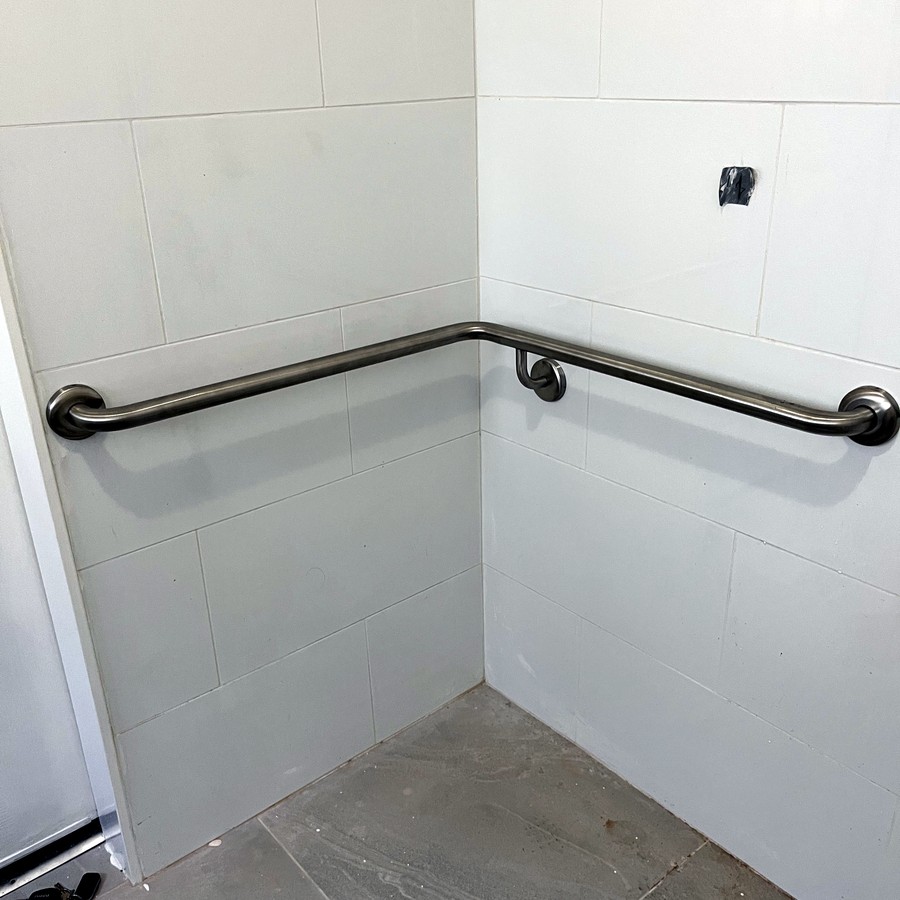 Long angled grab rail in a tiled shower