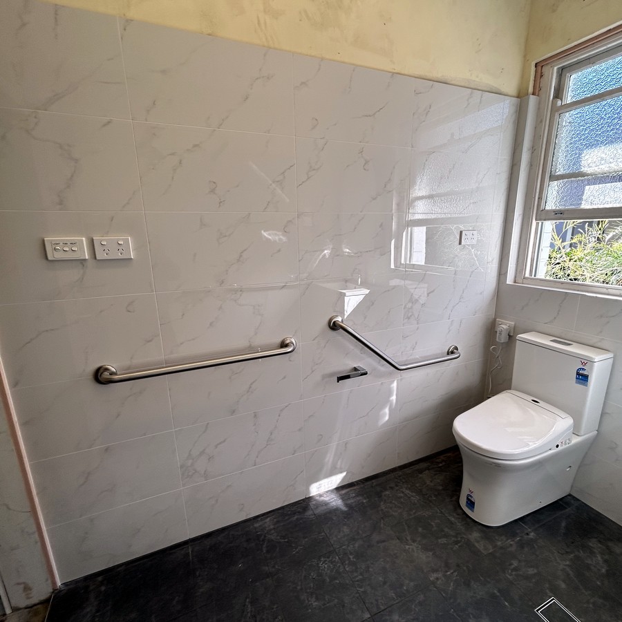 Accessible bathroom with grab rails and a walk-in shower