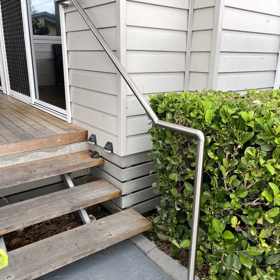 Stainless steel handrail on timber entry steps
