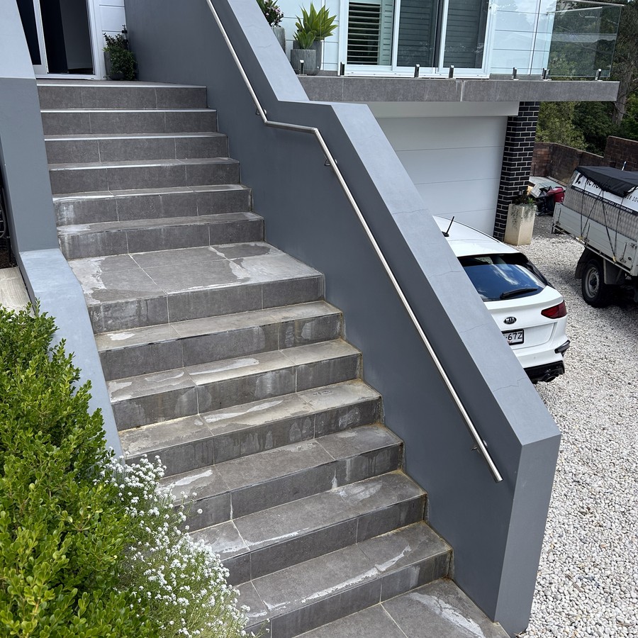 Stainless steel handrail along long concrete steps