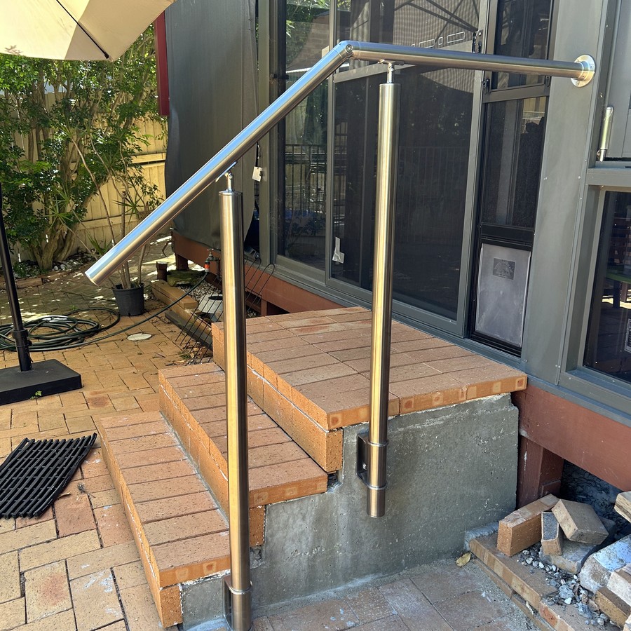 Stainless steel handrail and glass balustrade on a timber deck