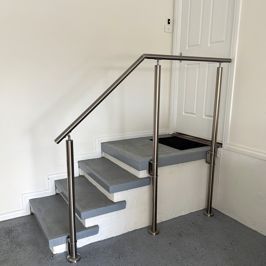 Modern stainless steel handrail and posts on entry steps