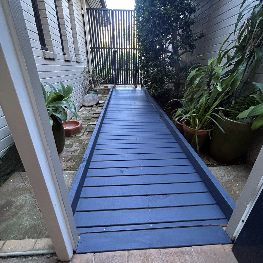 Long timber walkway ramp alongside a home