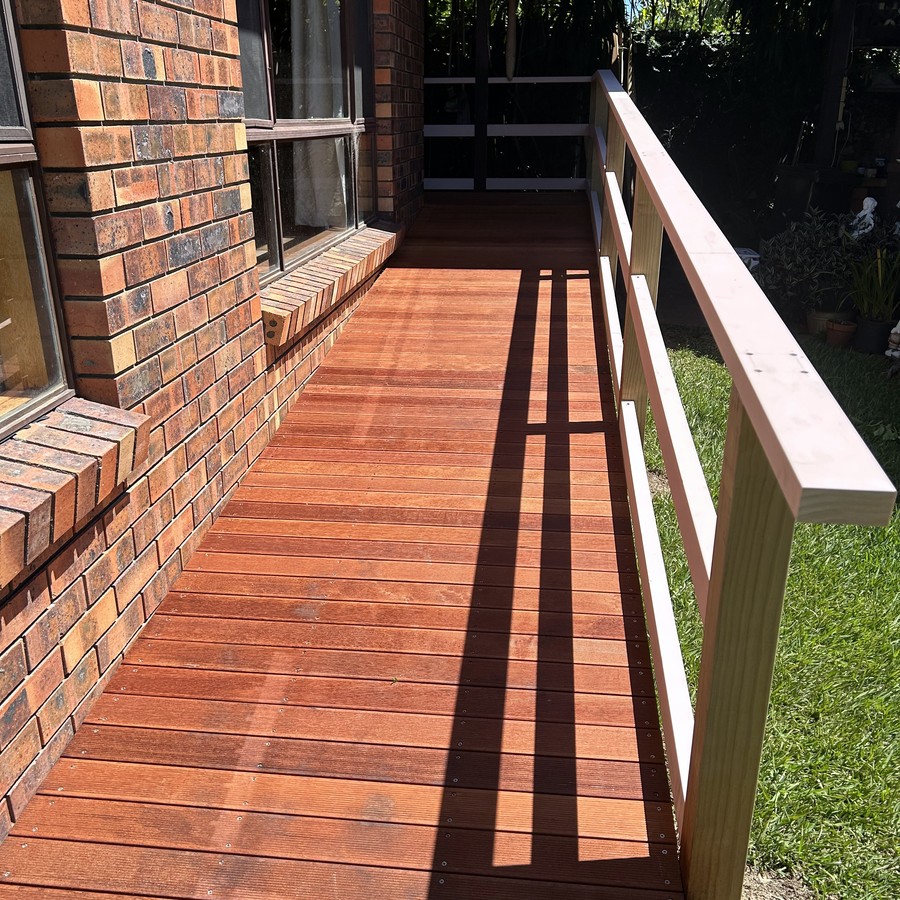 Timber access ramp with a timber balustrade alongside a home